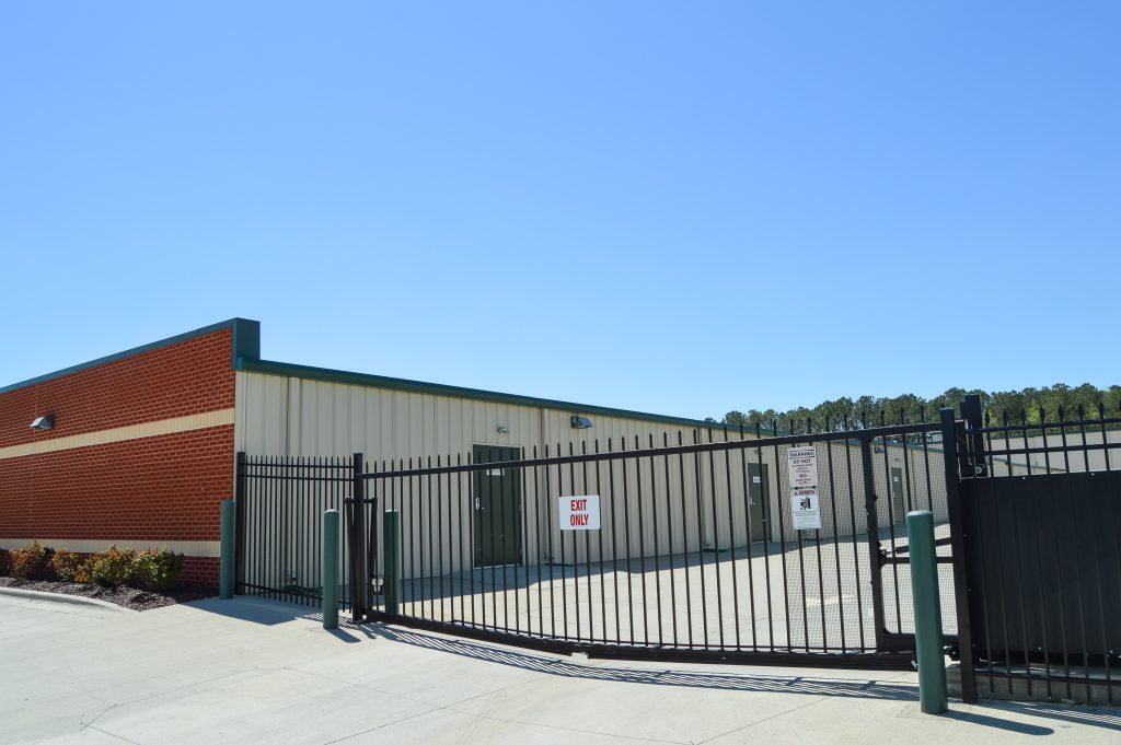 Exterior of Ample Storage Apex facility, view of security gate.